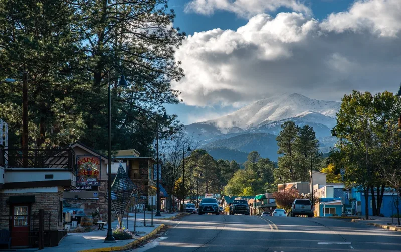 Midtown Ruidoso storefronts with snowy Sierra Blanca in view
