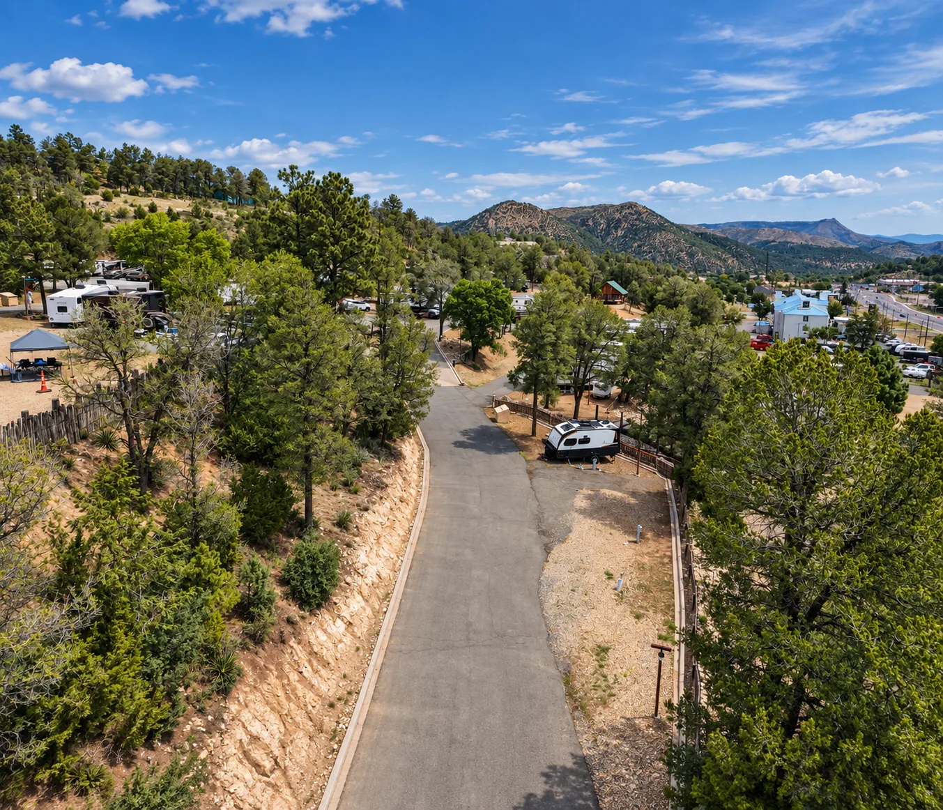 Park road stepping through the hillside toward the Ruidoso mountains